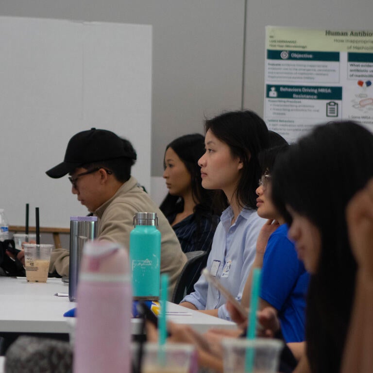 Image of Students Focused on the Symposium