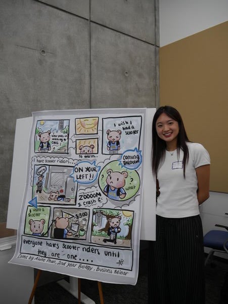 Student standing by her poster about scooter traffic at UCR