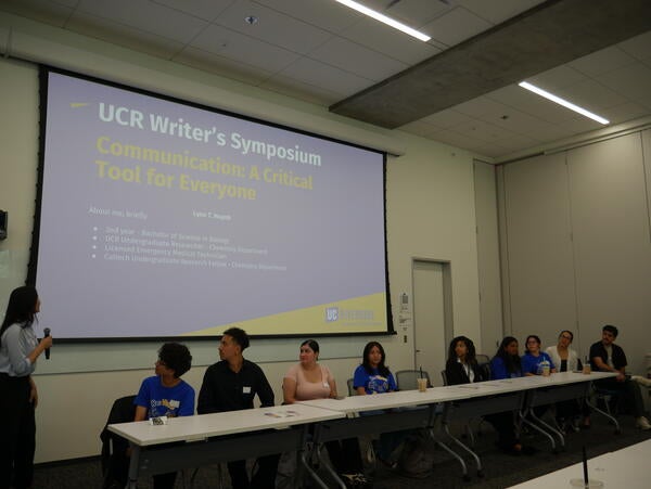 Students presenting at the Rewrite Rebuild Symposium, fittingly, on the topic of communication.