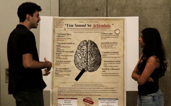 Students discussing poster about language