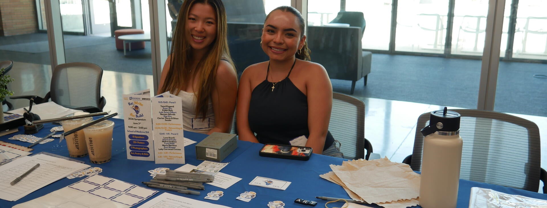 Students assisting with sign ins and celebrating community with boba