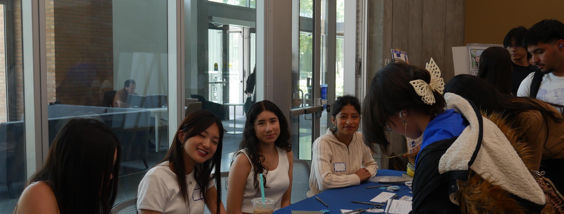 Students helping others sign in and celebrating community achievements