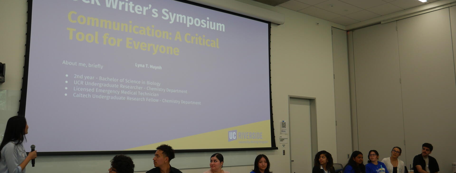 Students presenting at the Rewrite Rebuild Symposium, fittingly, on the topic of communication.
